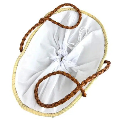 Panier beige naturel vu de dessus, doublure blanche resserrée par un cordon et poignées en cuir marron tressé.
