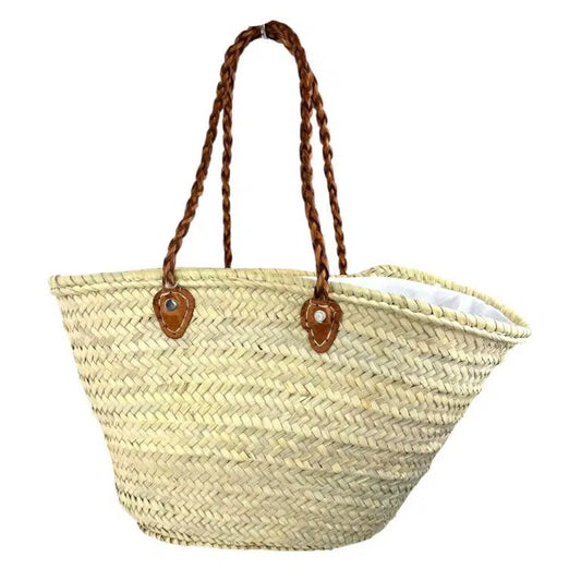 Grand panier de plage en fibre naturelle beige, avec longues poignées en cuir marron tressé
