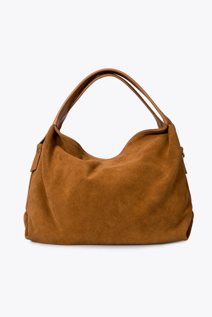 Sac à main Capucine en cuir velours couleur beige, vu de face sur fond clair, avec ses deux anses.